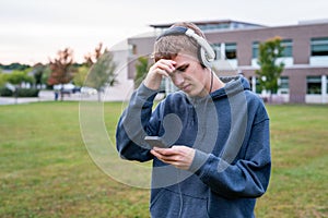 Upset teenager listening to music.