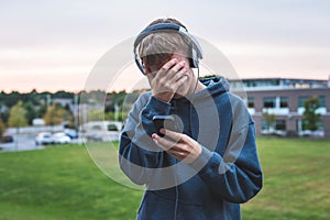 Upset teenager listening to music.