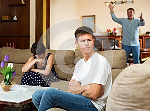 Upset teenager and mother with scolding father