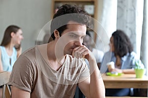 Upset thoughtful man sitting alone, low self-esteem, have no friends