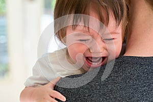 Upset toddler boy crying in his house
