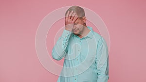 Upset tourist stylish man making face palm gesture, feeling bored, disappointed in result, bad news