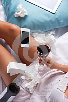 Upset woman after breakup drinking wine