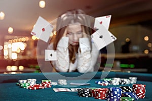 Upset woman in casino with falling cards