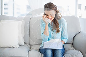 Upset woman crying sitting on sofa