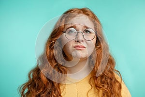 Upset and woman with her damaged dry hair face expression blue background