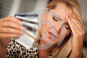 Upset Woman Holding Her Many Credit Cards