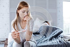 Upset woman holding her pregnancy test