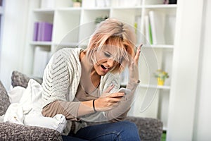 Upset woman looking at mobile phone