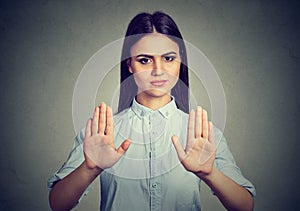 Upset woman repulsing something with hands stop gesture