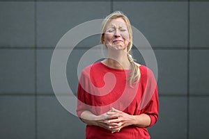 Upset woman screwing up her face in anguish photo