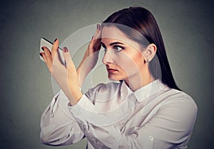 Upset woman surprised she is losing hair has receding hairline