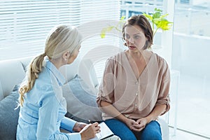 Upset woman talking to therapist