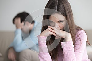 Upset young couple after arguing, sad thoughtful woman looking w