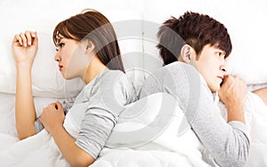 Upset young couple lying side by side