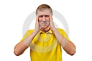 Upset young male in yellow T-shirt clutched at head, forgetful man, isolated on white background