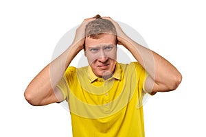 Upset young male in yellow T-shirt clutched at head, forgetful man, isolated on white background