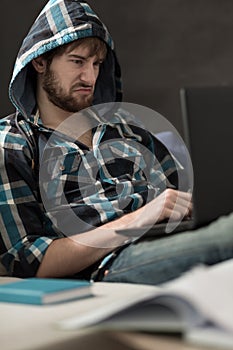 Upset young man with laptop