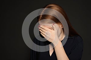 Upset young woman crying against background. Space for text