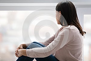 Upset young woman look in distance missing thinking