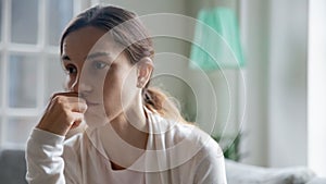 Upset young woman look in distance pondering