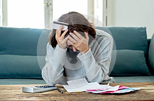 Upset young woman stressed about credit card debts and payments not happy accounting finances