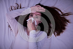 Upset young woman suffering from influenza at home