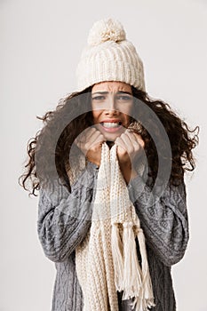 Upset young woman wearing winter scarf