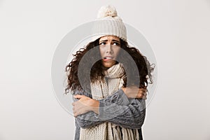 Upset young woman wearing winter scarf