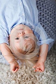 Upside down boy on pouf