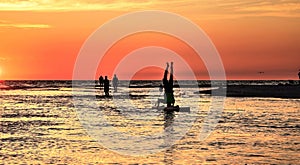 Upside down handstand on a Paddleboard done at sunset