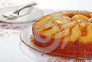 Upside down pear cake with plates and forks