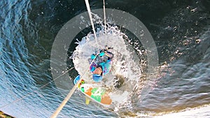 Upside-down view of a man falling from the board while kiting