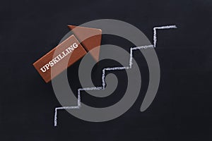 Upskilling red arrow with a ladder on a blackboard photo