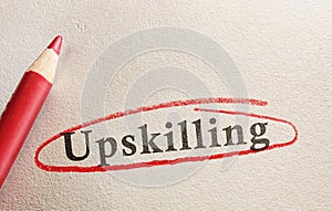 Upskilling text on paper circled in red pencil -- job training concept photo