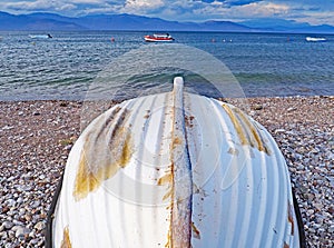 Upturned boat on Nikolaiika Beach and the Corinthian Gulf, Greece