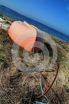 Upturned boat by sea