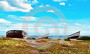 Upturned fishing boats on heath near shore