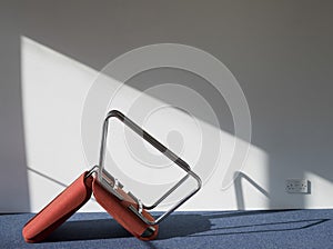 Upturned Office Chair Casting Shadow On Wall