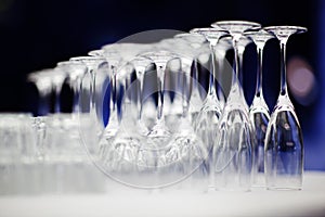 Upturned set of wine glasses on blurred blue