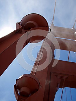 Upward perspective of Art Deco Lights, Tower and supporting cables on the Golden Gate Bridge