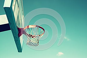 Upward view of basketball hoop against sky