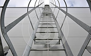 Upward view of a fire inspection ladder installed on the wall of a building or on chimneys. has a guide rope for tying the rope of