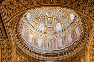 Upward view of gilded golden dome cupola inside St. Stephen`s Basilica in Budapest