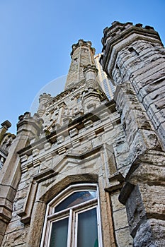 Upward view of old Chicago water tower with historic architecture building on blue sky day