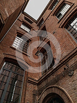 Upward view to high building red brick wall