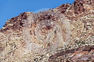 Upward view of the towering Chinle formations near Cassidy Arch at Capitol Reef National Park, Utah, USA