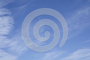 Upward view, wave of softy and white fluffy clouds under deep blue sky