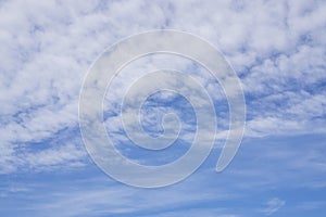 Upward view, wave of softy and white fluffy clouds under deep blue sky