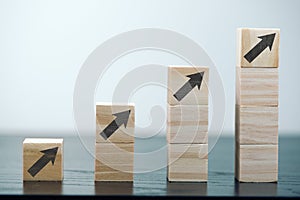 upwards pointing arrow symbols on stacks of wooden blocks